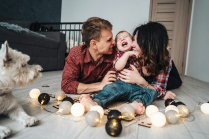 Happy family are playing together on the floor