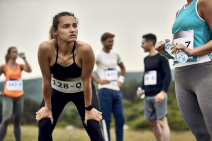 Pensive marathon runner concentrating before the race in nature.