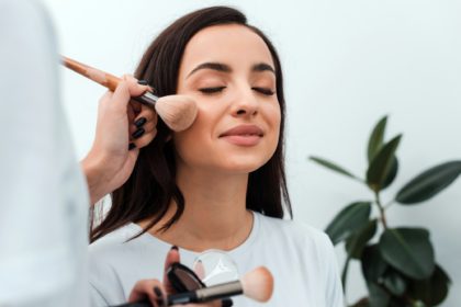 Professional Make-up artist doing glamour model makeup at work