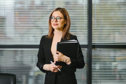 Smiling bank manager welcoming warm personality bright big smile in large building